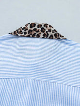 Short sleeve blue and white striped button-down shirt with a leopard print contrast collar for stylish wear