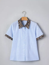 Light blue and white striped short sleeve blouse with leopard print collar and sleeve cuffs for stylish wear