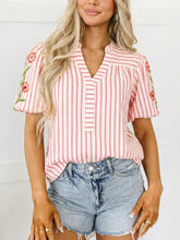 Pink and white striped blouse with floral embroidered puff sleeves, v neckline, and button closure for stylish wear