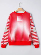 Red and white striped slightly stretchy long sleeve top with sequin santa patches and raw seam detail for christmas wear
