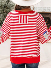Red and white striped slightly stretchy long sleeve sweater with sequin santa patch details machine wash safe