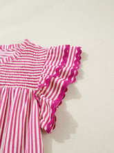 A vibrant pink and white striped ruffled short sleeve blouse with scalloped sleeve details and shirred yoke design