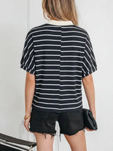 Black and white horizontally striped short sleeved top with stripe stand collar v neck and cream contrasting collar