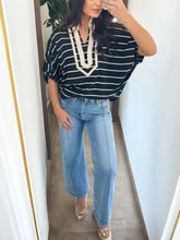 Black and white striped blouse with stripe stand collar v neck and cream embroidered detail on v neck area