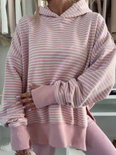 A soft pink and white striped loose fit hoodie with thumbholes and side slits machine wash cold recommended