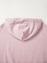 A soft pink and white vertically striped loose fit hoodie with thumbholes and side slits machine wash cold