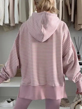 A soft pink and white striped oversized stripe thumbhole side slits drop shoulder loose fit hoodie machine wash cold