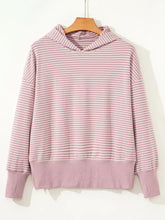 A soft lavender and white striped loose fit hoodie with thumbholes and side slits, machine wash cold recommended