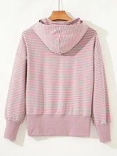 A soft pink and white striped loose fit hoodie with ribbed cuffs and side slits machine wash cold