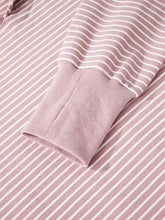 A soft pink and white striped long-sleeved stripe thumbhole side slits drop shoulder loose fit hoodie machine wash cold