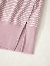 A soft lavender and white striped stripe thumbhole side slits drop shoulder loose fit hoodie with ribbed knit hem machine wash cold