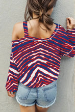 Women’s striped asymmetrical neck long sleeve zebra print top with denim shorts