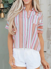 Striped button-down short sleeve shirt featuring vertical stripes in peach light gray and pink hues