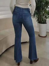 Blue denim flare jeans with vertical white stripes button fly and frayed hem in striped button fly flare style