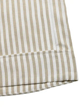 Close-up of beige and white striped fabric in wide leg jumpsuit