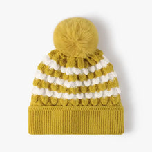 Striped contrast knit hat in yellow and white with fluffy imitation rabbit fur pom-pom