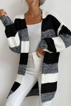 Black and white striped knit cardigan with textured design, long sleeves, pockets