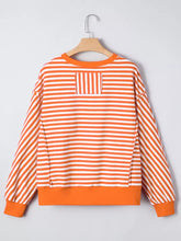 Striped long sleeve casual sweatshirt with orange and white horizontal stripes and solid orange ribbed neckline cuffs and hem