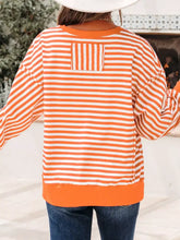 Striped long sleeve casual sweatshirt with orange and white horizontal stripes and solid orange hem cuffs and neckline