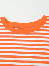 A vibrant orange and white horizontally striped long sleeve casual sweatshirt made of cotton with a ribbed crew neck