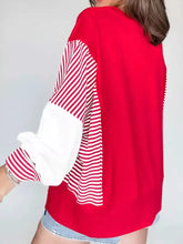 Striped patchwork sleeve colorblock sweatshirt with red and white sleeves and solid red body, slightly stretchy and machine wash