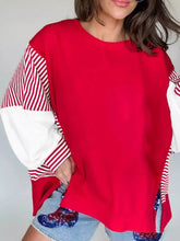 Red oversized striped patchwork sleeve colorblock sweatshirt with slightly stretchy fabric and machine wash care instructions