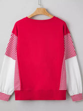 Striped patchwork sleeve colorblock sweatshirt with red and white slightly stretchy striped sleeves, machine wash care instructions