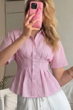 Pink pinstriped peplum blouse with short sleeves and button front detail for a stylish casual look