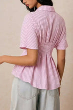 Pink short-sleeved striped peplum button up blouse with fine vertical stripes and a fitted hem suitable for casual wear