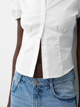 White fitted shirt with puffed sleeves and a slightly corseted silhouette featuring a striped puff sleeve design