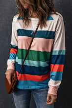 Woman in striped raglan long sleeve top with textured back, jeans, brown bag