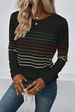 Woman in striped round neck long sleeve T-shirt holding white coffee cup