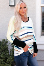 Woman in striped round neck long sleeve top with moderate stretch