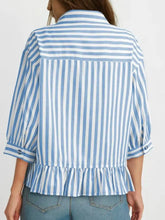 Blue and white vertically striped ruffle hem button-down shirt with three-quarter length sleeves and a ruffle hem