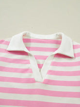 A pink and white striped polo shirt with a crisp white collar featuring ruffled sleeve details