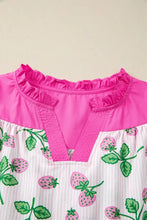 A vibrant pink and white strawberry-print color block patchwork flutter sleeve blouse with a ruffled neckline