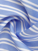 Blue and white striped tie-front peplum cami with soft woven fabric and a flattering peplum silhouette