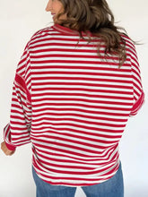 Striped v-neck long sleeve sweatshirt with red and white horizontal stripes and relaxed fit machine wash cold