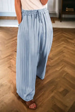 Light blue striped wide leg jeans with a drawstring waistband for a comfortable casual look