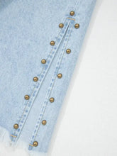 Light blue denim wide leg jeans with gold-toned studs along the side slit leg frayed hem and pockets