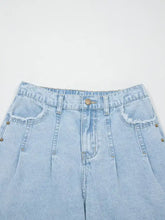 Light-wash denim studded side slit leg frayed wide leg jeans with pocketed design and gold-tone studs along seams