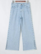 Light-wash denim studded wide-leg jeans with slit leg frayed hems and pockets for stylish casual wear