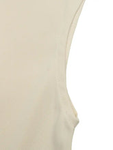 Cream-colored surplice cap sleeve bodysuit with sleeveless design and fine matching thread stitching along armhole