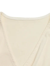 Cream-colored surplice cap sleeve bodysuit with v-neck and smooth lightweight fabric for elegant wear