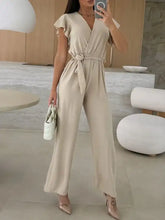 Surplice wide leg belted jumpsuit with flutter sleeves