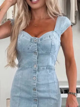 Light blue denim dress with sweetheart neckline cap sleeves and front button closure made of denim material