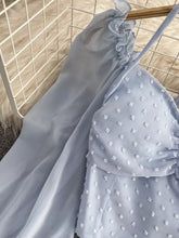Swiss dot flounce sleeve blouse in light blue sheer fabric with ruffled neckline and white floral embellishments