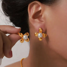 Gold-tone titanium steel flower earrings with synthetic pearl center