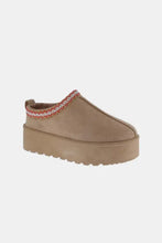 Tan platform slip-on boots with embroidered trim, 2-inch heel height