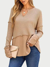 Tan waffle knit long sleeve top with beige layered bell sleeves and V-neck